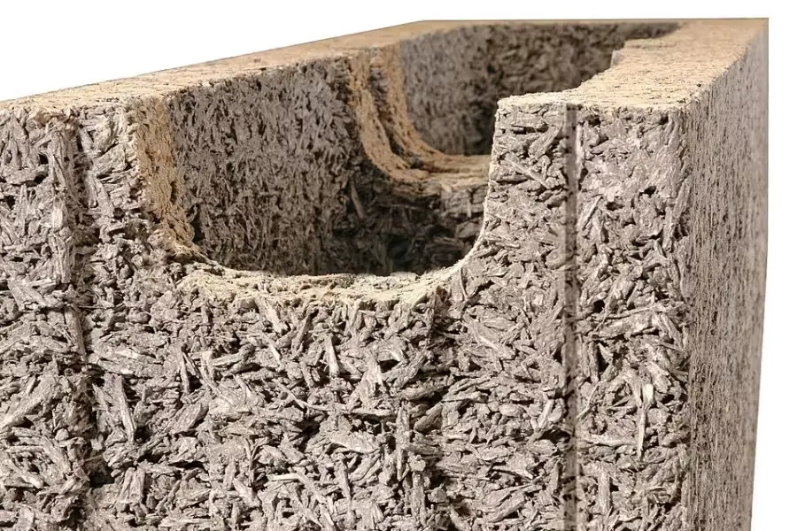 Cut-away of a cement-bound wood-composite form block, showing its coarse texture and hollow core